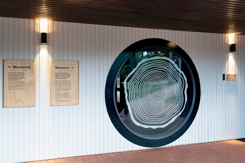 State Timber Museum entrance with circular tree-ring window and wayfinding signage